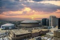 aerial shot of the Caesars Superdome and the Smoothie King Center with skyscrapers, office buildings and hotels
