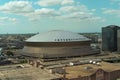 aerial shot of the Caesars Superdome and the Smoothie King Center with skyscrapers, office buildings and hotels