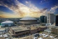 aerial shot of the Caesars Superdome and the Smoothie King Center with skyscrapers, office buildings and hotels