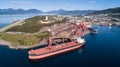 Aerial shot of a cargo ship anchoring in port terminal and loading iron ore Royalty Free Stock Photo