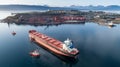 Aerial shot of a cargo ship approaching port terminal with help of towing ship Royalty Free Stock Photo