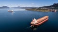 Aerial shot of a cargo ship on the open sea with other ship and mountains in the background Royalty Free Stock Photo