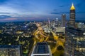 aerial shot of cars and trucks driving on the freeway in the middle of the city with skyscrapers, hotels and office buildings