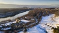 Aerial shot of a city covered with snow near the frozen river in winter Royalty Free Stock Photo