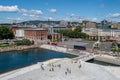 Aerial shot of the city of Oslo and people walking along a canal on a sunny summer day