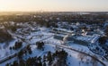 Aerial shot of a cityscape covered with a lot of buildings and trees covered with snow