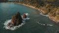 Aerial shot of a cliffy seashore near the ocean in daylight