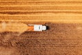 Aerial shot of combine harvester machine harvesting ripe wheat crop in summer Royalty Free Stock Photo