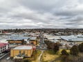 Aerial shot of country town buildings, street, cars, clouds and the skyline in Armidale, Australia