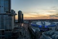 aerial shot of Crypto.com Arena and the Los Angeles Convention Center at sunset with cars driving on the street, skyscrapers