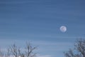 Aerial shot of daytime moon on blue sky Royalty Free Stock Photo