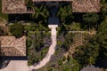 Aerial shot of the entrance of a villa of a luxurious private residence with palm trees