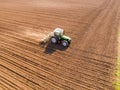 Aerial shot of a farmer seeding, sowing crops at field. Royalty Free Stock Photo