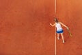 Aerial shot of a female tennis player on a court during match. Young woman playing tennis.High angle view. Royalty Free Stock Photo