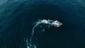 Fishermen in small boat trawling sardines and sea fish in ocean