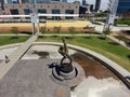 aerial shot of the The Flair Olympic Statue in Georgia International Plaza with lush green trees and grass