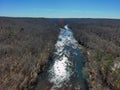 an aerial shot of the flowing waters of the river at Lower Pool West at Lake Lanier with bare winter trees