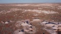 aerial shot flying forward over opal mines and mullock heaps at coober pedy