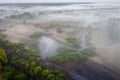 Aerial shot of Foggy nature in the morning. Fog on riverside. Misty landscape from above. Autumn background Royalty Free Stock Photo