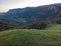 Aerial shot of a girl in an amazing mountain landscape in Transylvania, Romania