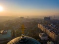 Aerial shot of the golden cross on top of Saint Sava temple cupola in Belgrade with air pollution in the background Royalty Free Stock Photo