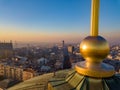 Aerial shot of the golden cross on top of Saint Sava temple cupola in Belgrade with Terazije and Beogradjanka building in the Royalty Free Stock Photo
