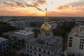 aerial shot of the golden dome on top of Savannah City Hall with an American flag on top and a stunning sunset Royalty Free Stock Photo