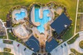 Aerial shot of green lawn, swimming pool, lounge area near beautiful mansion in the courtyard. Royalty Free Stock Photo