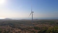 Aerial shot of a group of wind turbines in a semidesert environment. Green energy concept