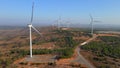 Aerial shot of a group of wind turbines in a semidesert environment. Green energy concept