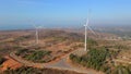 Aerial shot of a group of wind turbines in a semidesert environment. Green energy concept