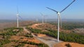 Aerial shot of a group of wind turbines in a semidesert environment. Green energy concept