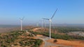 Aerial shot of a group of wind turbines in a semidesert environment. Green energy concept