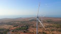 Aerial shot of a group of wind turbines in a semidesert environment. Green energy concept