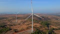 Aerial shot of a group of wind turbines in a semidesert environment. Green energy concept