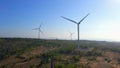 Aerial shot of a group of wind turbines in a semidesert environment. Green energy concept