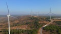 Aerial shot of a group of wind turbines in a semidesert environment. Green energy concept