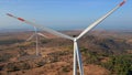 Aerial shot of a group of wind turbines in a semidesert environment. Green energy concept