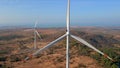 Aerial shot of a group of wind turbines in a semidesert environment. Green energy concept