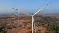 Aerial shot of a group of wind turbines in a semidesert environment. Green energy concept