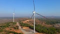 Aerial shot of a group of wind turbines in a semidesert environment. Green energy concept