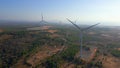 Aerial shot of a group of wind turbines in a semidesert environment. Green energy concept