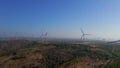 Aerial shot of a group of wind turbines in a semidesert environment. Green energy concept