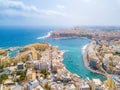 Aerial shot of high rise buildings near the sea in Spinola Bay, St. Julians and Sliema town on Malta
