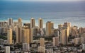 Aerial shot of the Honolulu cityscape against the ocean in Oahu, Hawaii