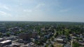 aerial shot of hotels, office buildings and apartments in the city skyline and vast miles of lush green trees and grass