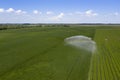 Aerial shot of irrigation sprayer irrigating cultivated fields Royalty Free Stock Photo