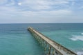 aerial shot of Johnnie Mercer\'s Fishing Pier with vast blue ocean water and people walking along the pier, blue sky