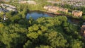 Aerial shot of a large canal in a green landscape during the day