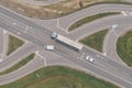 Aerial shot of large semi-truck, a van and a pickup truck on road intersection from drone pov
